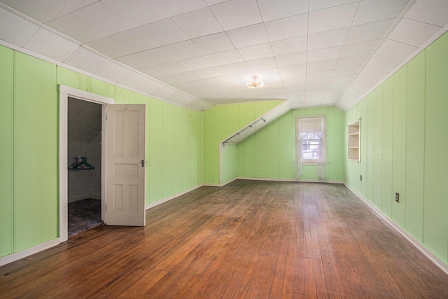 additional living space with dark hardwood / wood-style floors and lofted ceiling