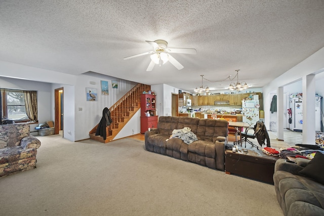 carpeted living room with a textured ceiling and ceiling fan with notable chandelier