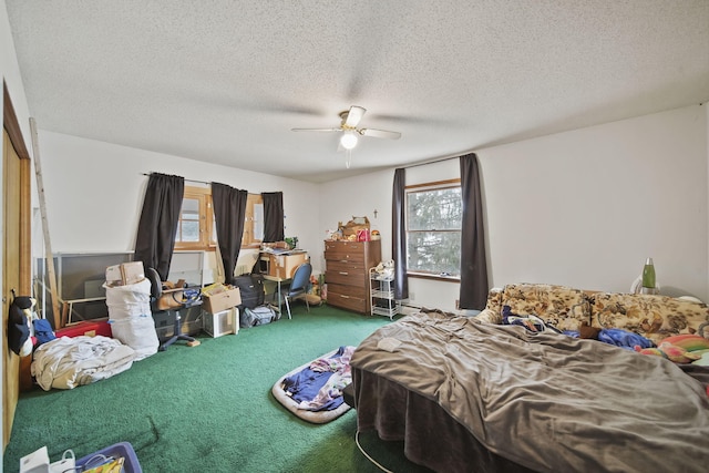 bedroom featuring multiple windows, a textured ceiling, carpet floors, and ceiling fan