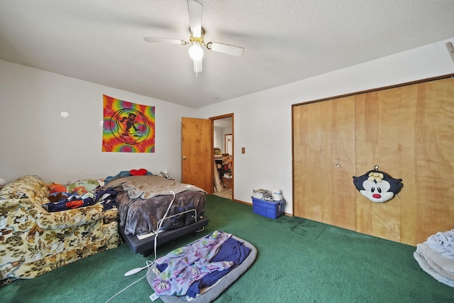 carpeted bedroom featuring a textured ceiling, a closet, and ceiling fan