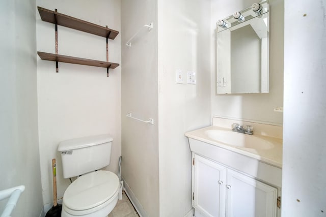 bathroom with tile patterned flooring, vanity, and toilet