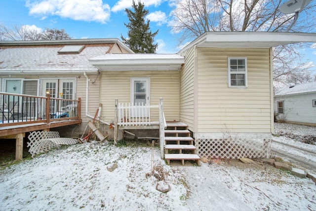 view of snow covered rear of property