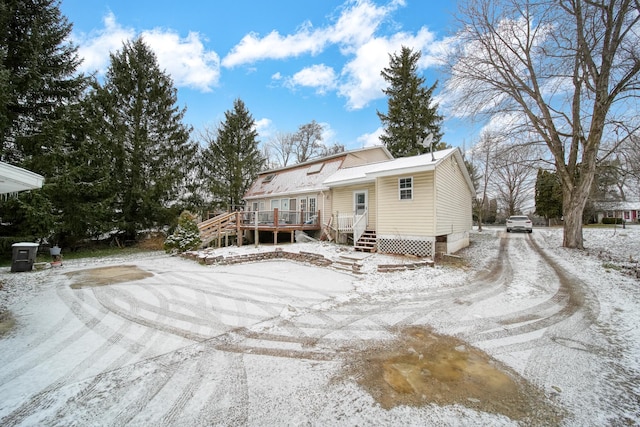 snow covered property featuring a wooden deck