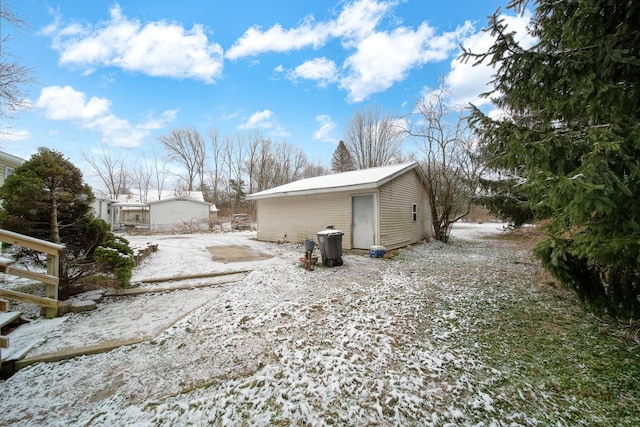 view of snowy exterior featuring an outdoor structure