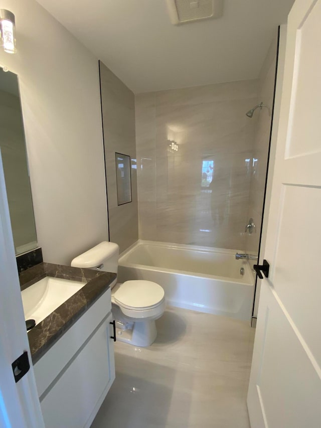 full bathroom featuring vanity, toilet, and tiled shower / bath combo