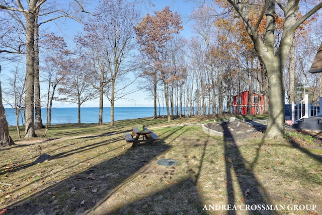 view of yard with an outbuilding and a water view