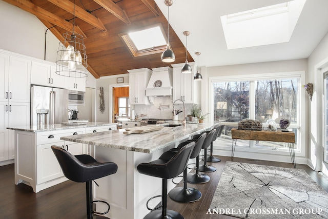 kitchen with wood ceiling, stainless steel appliances, pendant lighting, white cabinets, and dark hardwood / wood-style floors