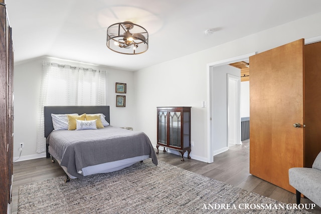 bedroom with lofted ceiling and hardwood / wood-style flooring