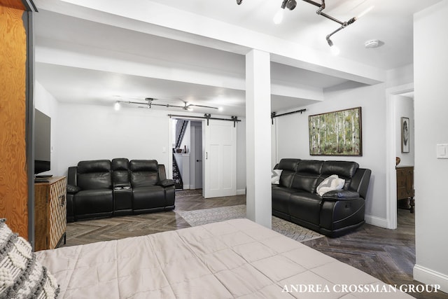 bedroom featuring a barn door and parquet floors