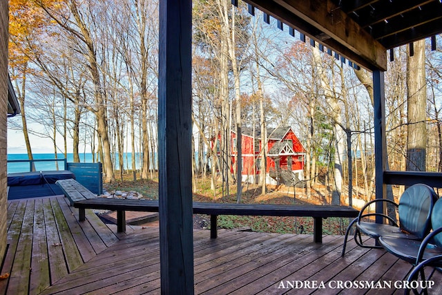 wooden terrace featuring a storage unit and a water view