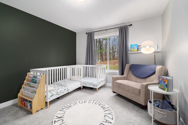 carpeted bedroom featuring a crib