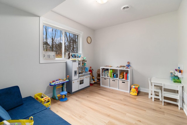 playroom with light hardwood / wood-style floors