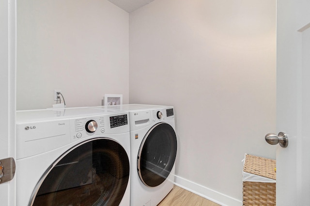 laundry room featuring hardwood / wood-style floors and separate washer and dryer