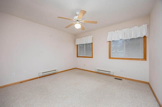 carpeted spare room featuring ceiling fan and a baseboard heating unit