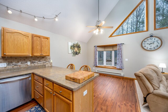 kitchen with dishwasher, dark hardwood / wood-style flooring, a baseboard radiator, and kitchen peninsula