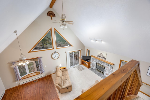 living room with beam ceiling, ceiling fan, high vaulted ceiling, a fireplace, and hardwood / wood-style flooring