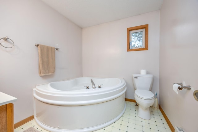 bathroom with tile patterned flooring, vanity, toilet, and a bath