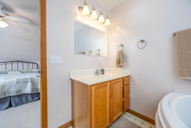 bathroom with tile patterned flooring, ceiling fan, and vanity