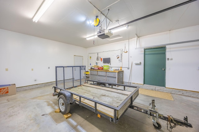 garage with a workshop area and a garage door opener