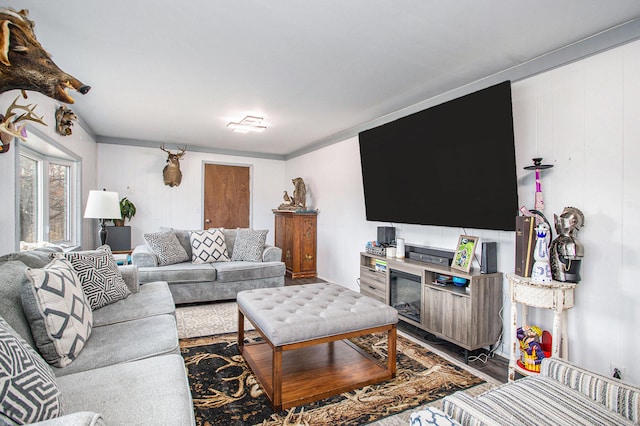 living room featuring hardwood / wood-style floors and crown molding