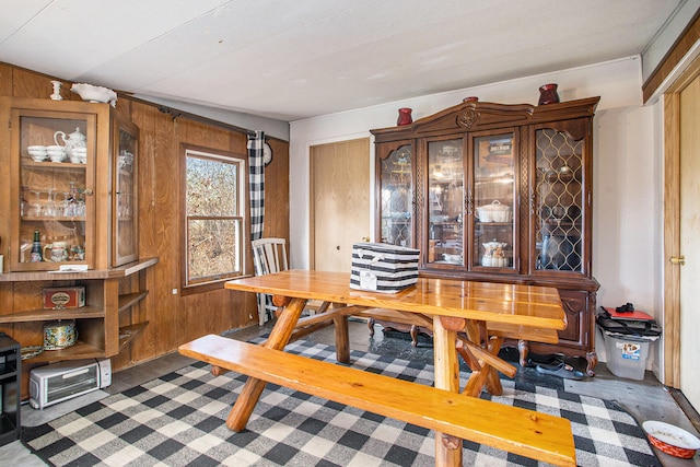 dining room featuring wooden walls