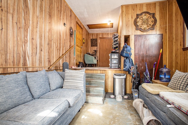 living room with wooden walls and concrete floors