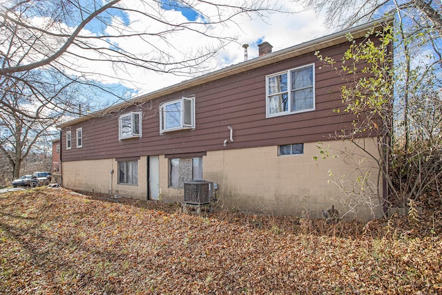 view of property exterior with central AC