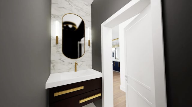 bathroom with hardwood / wood-style floors and vanity