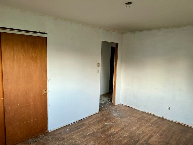 unfurnished room with dark hardwood / wood-style flooring