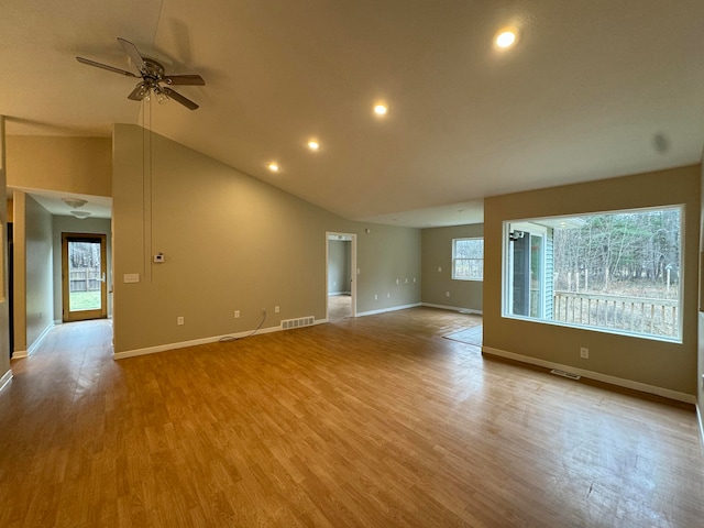 spare room with ceiling fan, lofted ceiling, and light hardwood / wood-style flooring