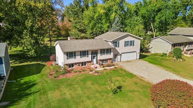 split foyer home featuring a front yard and a garage