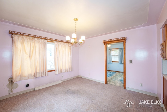 unfurnished room with an inviting chandelier and carpet