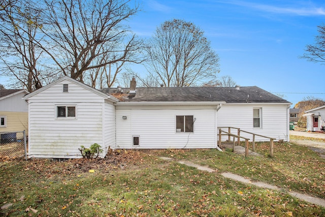 rear view of house featuring a yard