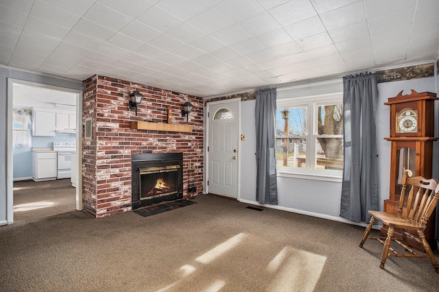 unfurnished living room with carpet and a brick fireplace