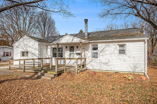 rear view of house featuring a deck