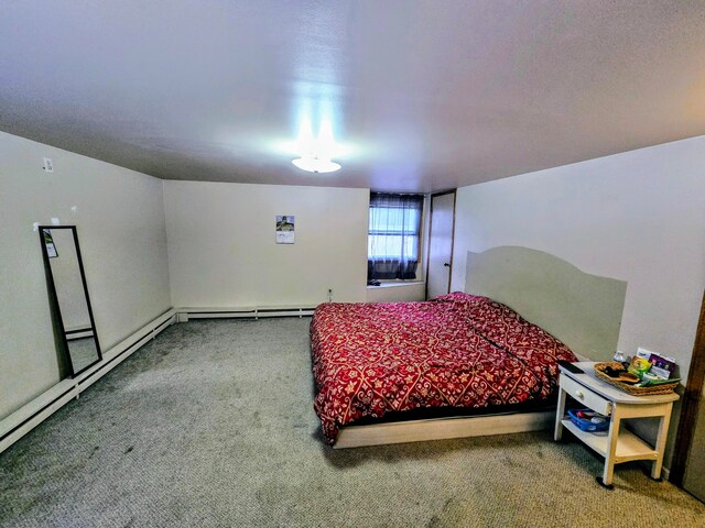 bedroom with carpet flooring and a baseboard radiator