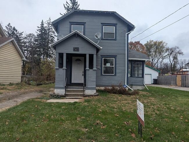 front facade featuring a garage, an outbuilding, and a front lawn