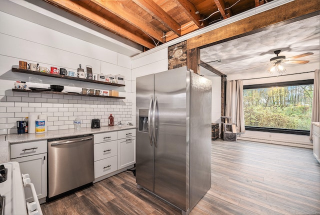 kitchen with decorative backsplash, white cabinets, dark wood-type flooring, and appliances with stainless steel finishes