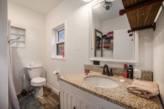 bathroom with hardwood / wood-style flooring, vanity, toilet, and tile walls