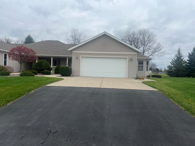 ranch-style house with a garage and a front lawn