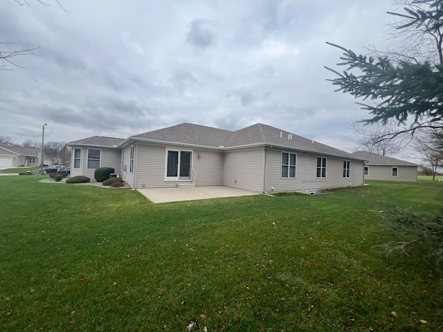 back of property featuring a lawn and a patio