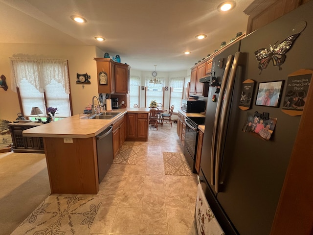 kitchen with hanging light fixtures, sink, a healthy amount of sunlight, and appliances with stainless steel finishes