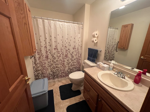 bathroom with tile patterned flooring, vanity, and toilet