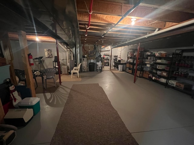 basement with secured water heater, heating unit, and water heater