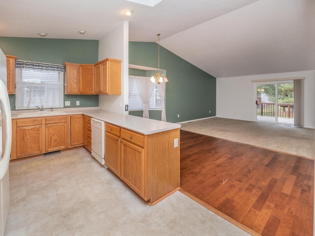 kitchen featuring dishwasher, kitchen peninsula, light colored carpet, decorative light fixtures, and lofted ceiling