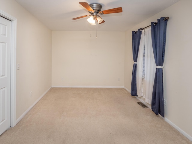 unfurnished room with ceiling fan and light colored carpet