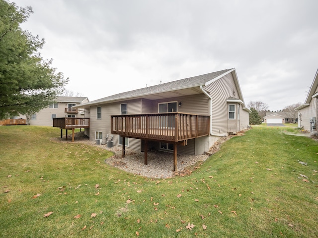 back of house featuring a wooden deck and a lawn