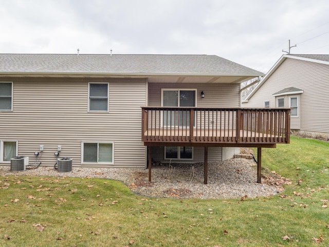 back of house with a lawn, central air condition unit, and a wooden deck