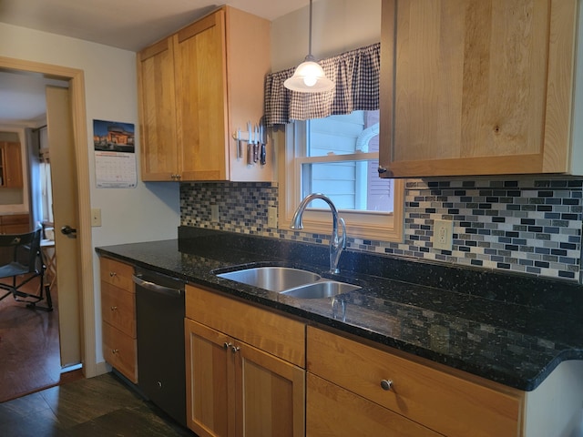 kitchen featuring stainless steel dishwasher, sink, dark stone countertops, dark hardwood / wood-style floors, and hanging light fixtures