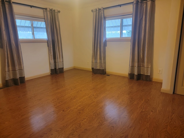 unfurnished room with crown molding and hardwood / wood-style floors